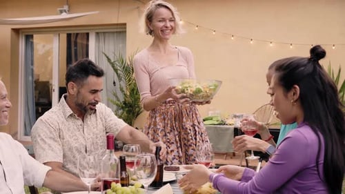 Friends Enjoying Outdoor Meal in Backyard