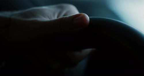 Close up young businessman is driving a new anonymous car just bought from auto deal. Slow motion