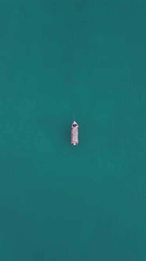 Aerial Drone Footage of Boat Floating on Crystal Clear Sea Water