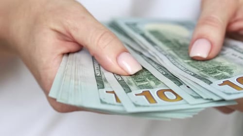 Counting Stack of United States One Hundred Dollar Bills