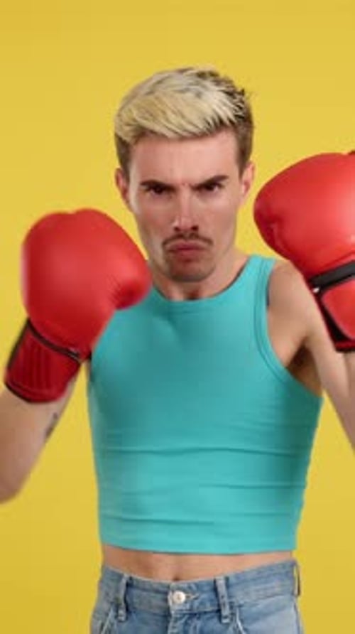 Young Adult Boxer in Stance on Yellow Background