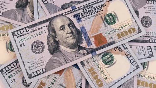 100 dollars bills close-up, slowly rotating background in a pile of hundreds of American US dollars.