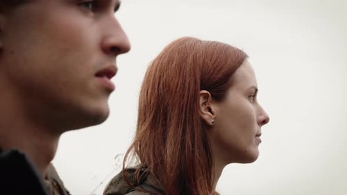 Young Man and Woman in Profile Outdoors