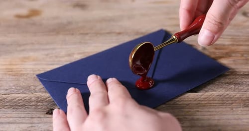 Pouring Wax Seal on an Envelope on a Table
