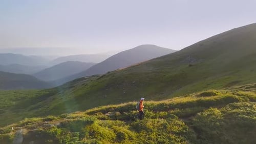 Tourist Hiker with a Backpack Running on Mountain Path in Carpathian Mountains