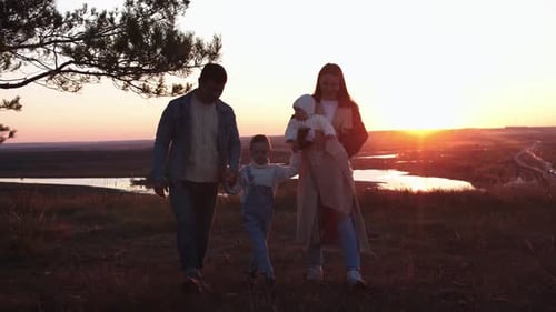 Family Walking at Park on Sunset