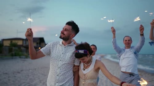 Friends Celebrate Together with Sparklers on Beach