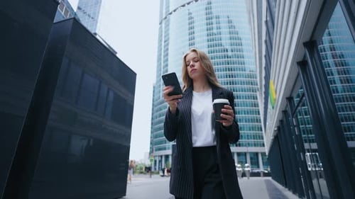 Young Businesswoman or Office Worker Walking in Morning in Business District Going to Work