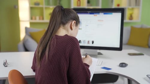 Woman is shopping in online internet stores from her home computer.