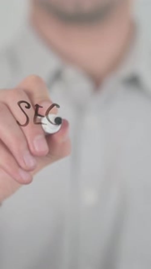 Man Writes 'Security System' on Glass with Marker