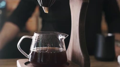 Coffee drips into a clear carafe