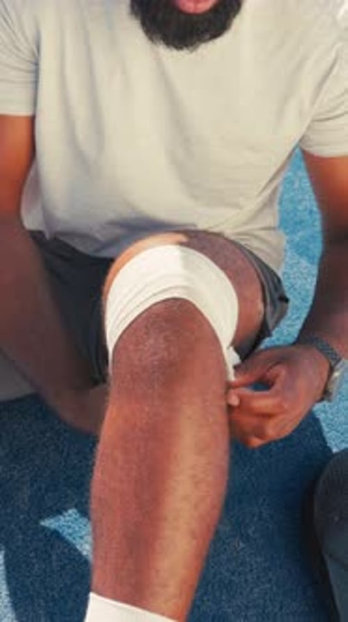 Bandage, sports injury and tennis court with knee of person for joint inflammation