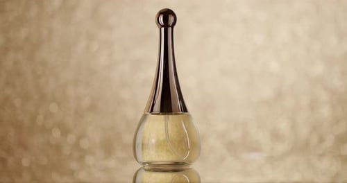 Elegant Perfume Bottle on Gold Sparkling Background