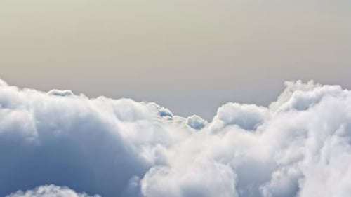 Drone view flying above sea of soft white clouds at sunset