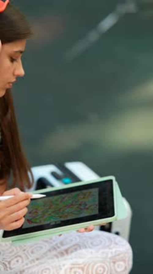Girl Drawing on Tablet in Urban Environment