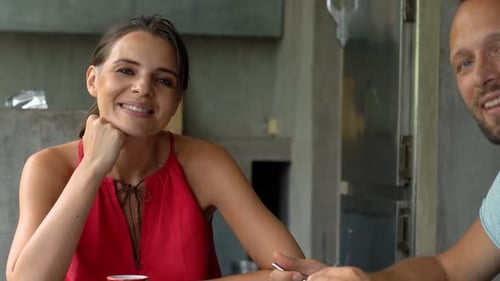 Happy Couple Talking at the Kitchen Table
