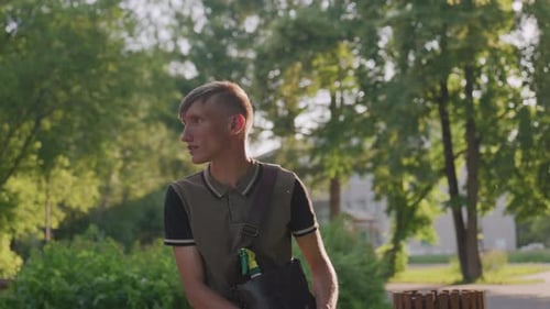 Caucasian Man Contemplative On Sunlit Park Bench Sitting Still And Gazing Toward Horizon Soft Golden