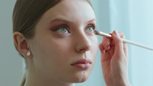 Makeup Artist Work in Her Beauty Studio Portrait of Woman Applying By Professional Make Up Master