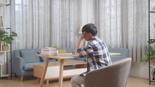 Back View Of Tired Teenager Having Headache While Learning At Home