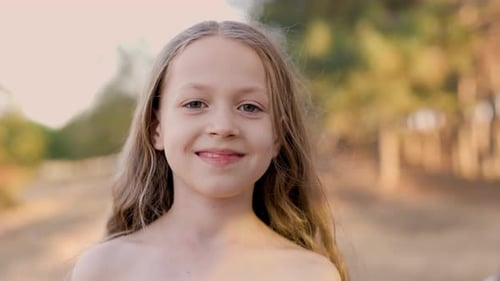 Happy Child Cute Blonde Girl Looks at Camera in Park Girl Smiles Happy Child in Park Summer Holidays
