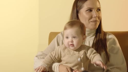 Loving Family Sitting Close Together in Living Room
