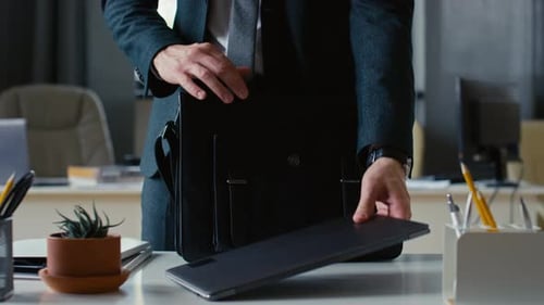 Businessman Packing and Leaving Office