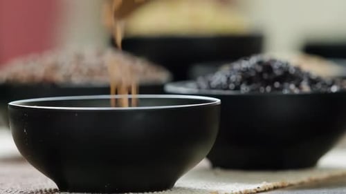 Close Up of Seeds being Poured into Bowl
