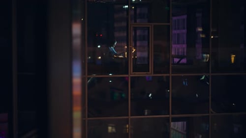 Night Window View Office Worker Reading Documents Working Late Typing Laptop