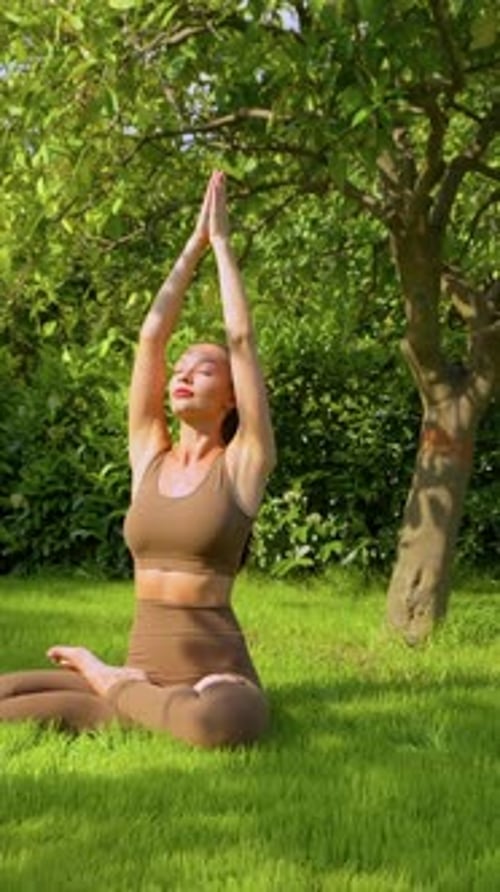 Woman Doing Yoga Outside on Green Lawn
