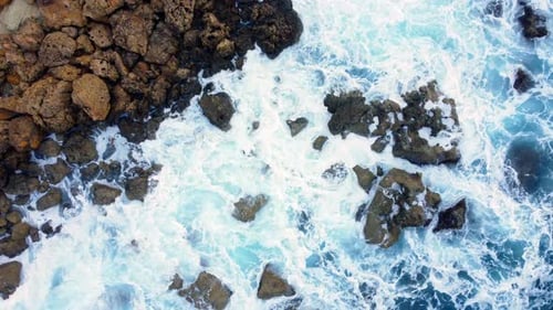 Ocean Coastline Cliffside with Blue Pure Water Sea Waves Washes the Rocky Shore Above Aerial Shot