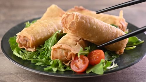 Crispy vegetables spring Rolls on Ceramic Plate on wooden table