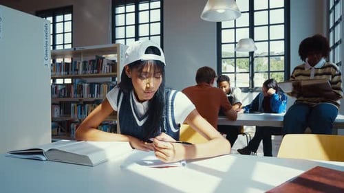 Young and cheerful multiethnic students reading books
