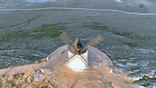 Incredible dynamic and cinematic drone shot of a historic windmill in Spain