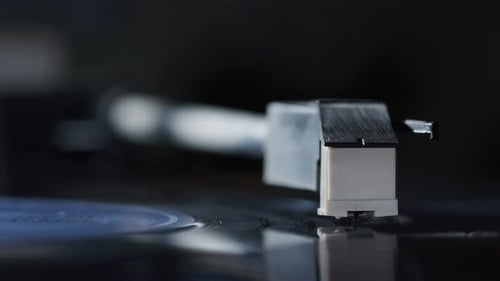 Stunning close up shot of the needle of a vinyl turntable record player as it plays a record and
