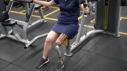 Woman with Prosthetic Leg Running on Track. Sportsperson Exercising at fitness gym