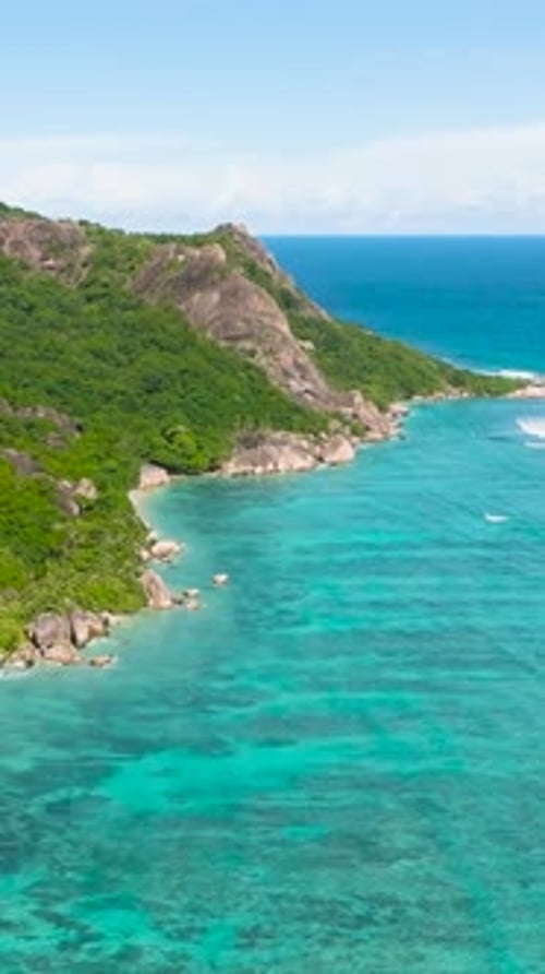 Clear Turquoise Water Along Tropical Shoreline and Rocks La Digue Seychelles