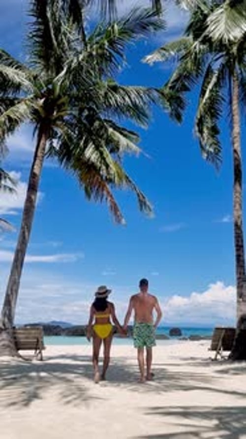 Couple Walking Hand in Hand Along the Serene Shores of Koh Mak Thailand