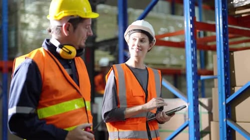 Warehouse Industrial and Logistics Companies. Dispatcher in uniform making inventory in storehouse.