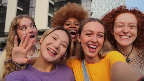 Happy Young Women Laughing Together in City