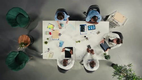 Top Down View of Doctors Participating in a Healthcare Team Meeting