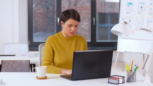 Woman working on laptop in modern office