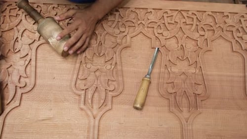 Woodworker Using Chisel and Mallet to Carve Wood