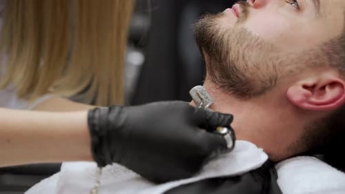 Barber Shaving Man's Neck with Straight Razor