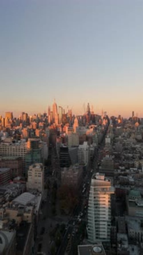 Camera Gliding Over Midtown Manhattan's Iconic Skyline During Golden Hour Highlighting NYC Cityscape