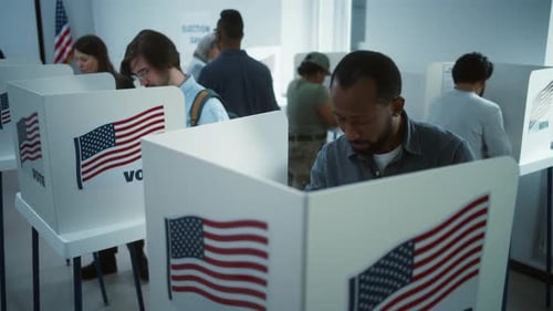 African American Man Comes to Vote in Booth in Polling Station
