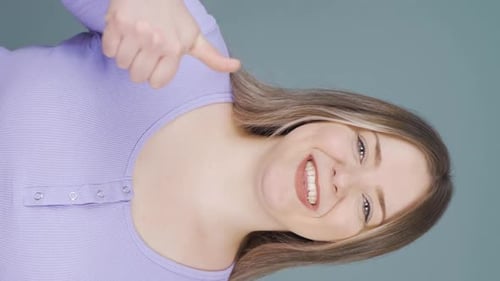 Smiling Woman Gives Thumbs Up and OK Sign