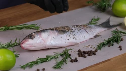 Salt the Mullet fish with salt grinder