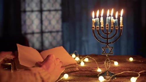 Hanukkah Menorah Lit with Old Book