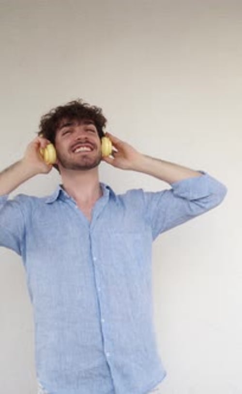Vertical Video Italian Man Dancing Laughing While Listening to Music with Headphones Funny Man