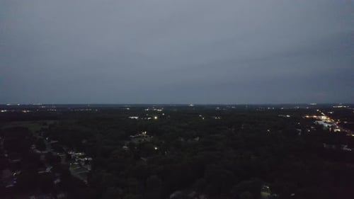 Aerial view of dark blue cloud with white light sky background and city light midnight